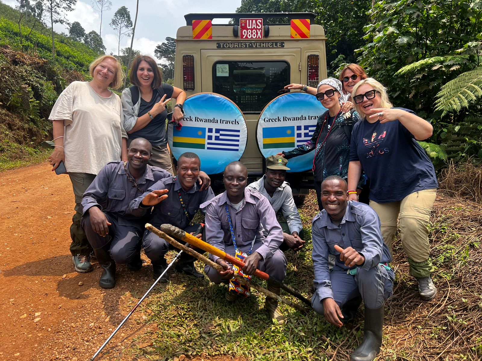 Trekkers and Rwanda Development Board rangers gathered after a successful gorilla trek in Volcanoes National Park